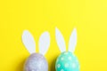 Nest with ÃÂolorful easter eggs, flowers and feathers on wooden background Royalty Free Stock Photo